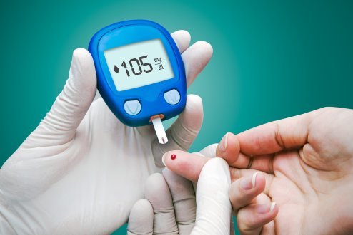 Doctor making blood sugar test.